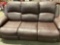 Brown Manual recliner couch with center console.