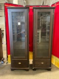 Set of two display cabinets with glass shelves and drawers on bottom.