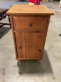Wood side table with drawer and storage.