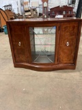 THOMASVILLE Entertainment center with glass shelves and glass front.
