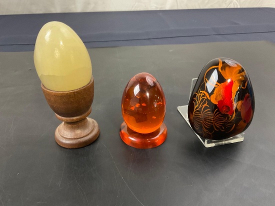 Handpainted Rock, Alabaster Egg, Acrylic Egg w/ Glitter, and three stands.
