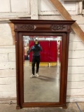 Large ornate antique wood-framed beveled mirror w/carved detail