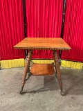 Vintage two-tiered claw foot table w/metal claws and lion accents