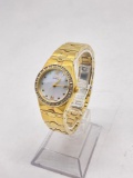Women's gold tone Citizen Eco Drive watch w/ mother of pearl face and diamond chip accents