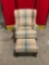 Vintage wooden upholstered armchair and ottoman