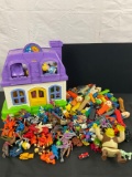 Large collection of vintage toys, action figures, Pez Dispenser and a fisher Price playset