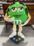 Green M&M Candy Plastic Store Rolling Display Stand. Very Good Condition. See pics.