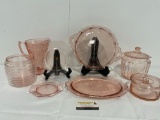Collection of Pink Depression Glass, Pitcher, Lidded Jars, Serving Plates, & more