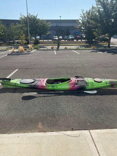 14 foot Wilderness Systems Tsunami 140 day-touring kayak with a paddle and a cover, used-good cond.