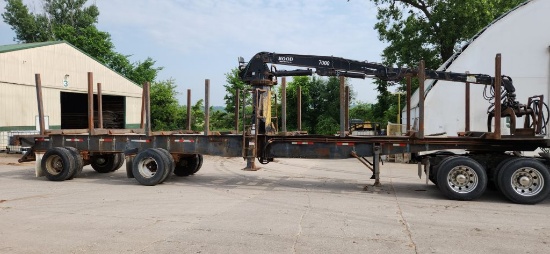 8 Bunk Tandem Spread 3 Axle Log Trailer With Mid-Mounted Hood 7000 Knuckle Boom Loader. Located At