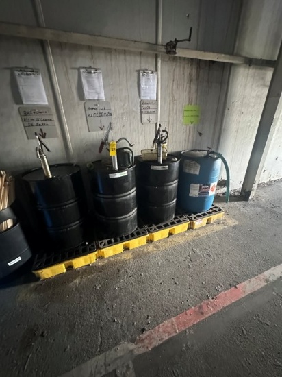 55 Gallon Drums of Oil and Washer Fluid with Hand Pumps and Spill Containment Platforms. 10W-30 Engi