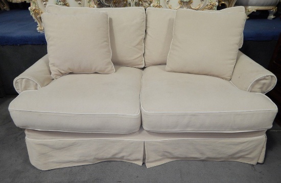 CREAM COLORED UPHOLSTERED LOVE SEAT