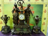 LARGE BRONZE FIGURAL MANTLE CLOCK AND MATCHING CANDLE STICKS