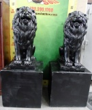 PAIR OF BLACK CEMENT LIONS WITH PEDESTALS