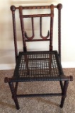 CARVED ANTIQUE SIDE CHAIR WITH CANE SEATING