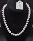 STRAND OF 18 INCH WHITE PEARLS WITH GOLD CLASP