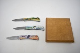 Three Folding Hunting Scene Knives with Display