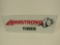 NOS Armstrong Tires horizontal tin sign with running Rhino graphic.