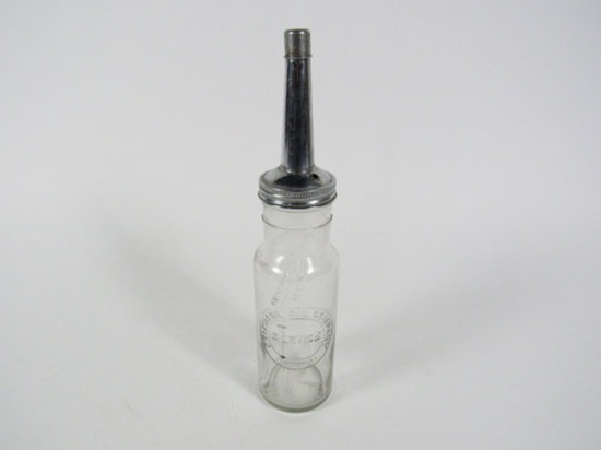 1930s Standard Oil Company embossed glass oil bottle with Standard Torch flame logo.