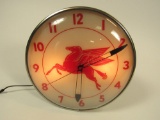 Spectacular circa early 1950s Mobil Oil glass-faced light-up clock with Pegasus logo.