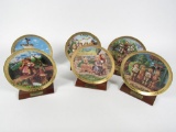 Lot of six Danbury Mint M.J. Hummel Century Plates on display stands with name plates.