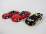 Lot consisting of three various diecast scale model cars.