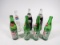 Lot of seven collectible glass soda bottles.