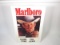 Marlboro Cigarettes single-sided embossed tin sign with Marlboro man graphic.