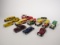 Box of 13 various die-cast and plastic delivery trucks and cars.