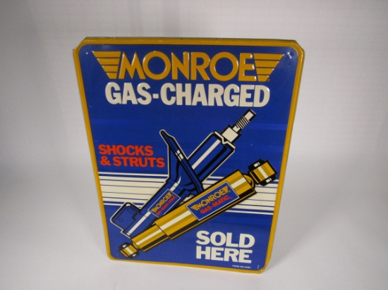 Monroe Shock Absorbers Sold Here single-sided embossed tin sign.