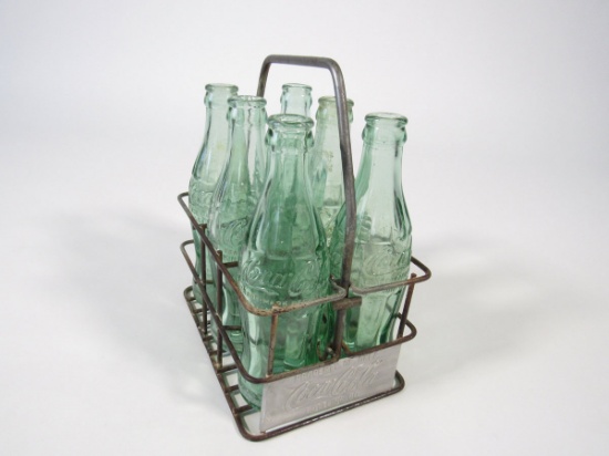 1930s Coca-Cola metal six-pack carrier with six period glass Coca-Cola bottles.