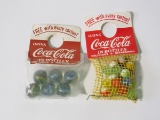 Lot of two circa 1940s-50s Coca-Cola promotional marbles still sealed in the original packaging.