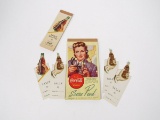 Lot consisting of a 1930s Coca-Cola bridge pad, 4-1930s die cut cardboard table Tally and a score.
