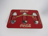 1930s Coca-Cola Masonite six-pack carrier with original string handle.