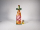 1930s Jack Sprat Evaporated Milk can and a 1938 Orange Spot Soda die-cut cardboard sign.