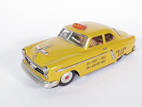 1954 Marusan of Japan friction drive yellow Ford taxi cab.