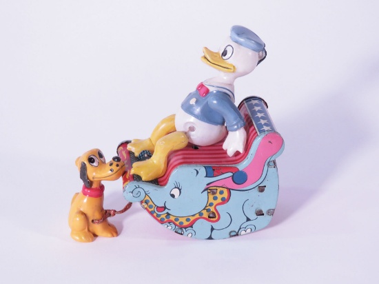 1950s Linemar Japan (Marx) celluloid Donald Duck riding a tin litho Dumbo the Flying Elephant sleigh