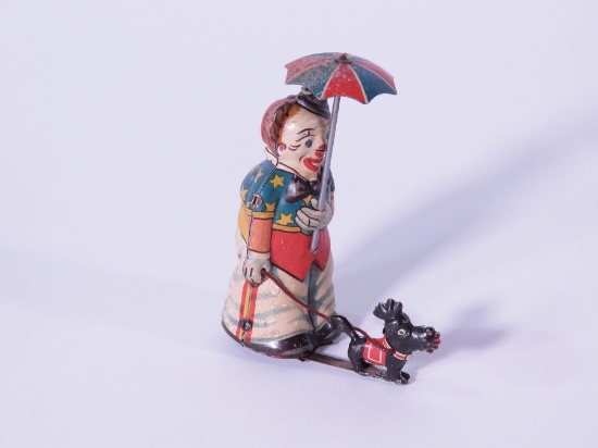 Neat circa 1930s German tin litho Clown with umbrella walking a dog key-wind walking toy.