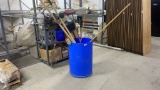 BARREL OF ASSORTED MOPS AND BROOMS