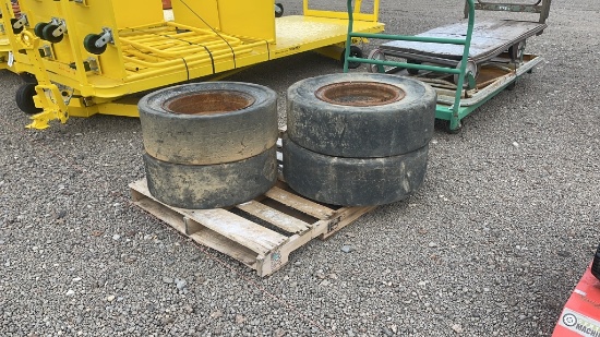 QTY 4) SOLID SKID STEER TIRES AND WHEELS