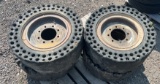 QTY 4) SKID STEER SOLID TIRES AND WHEELS