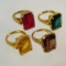 4 Gold Tone rings with colored glass stones