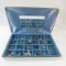 24 pairs of screw back earrings in partitioned box