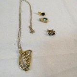 Gold tone jewelry with green stones
