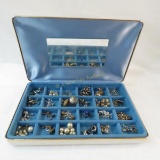 24 pairs of screw back earrings in partitioned box