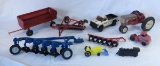 Metal toy tractors, implements, and plastic toys