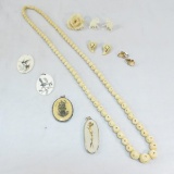 Carved bone, fossil, and scrimshaw jewelry