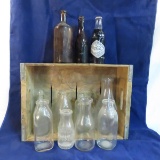 7Up crate with vintage soda and other bottles