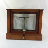 Antique balance scale in glass case