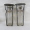 2 antique fire extinguisher bottles with cages